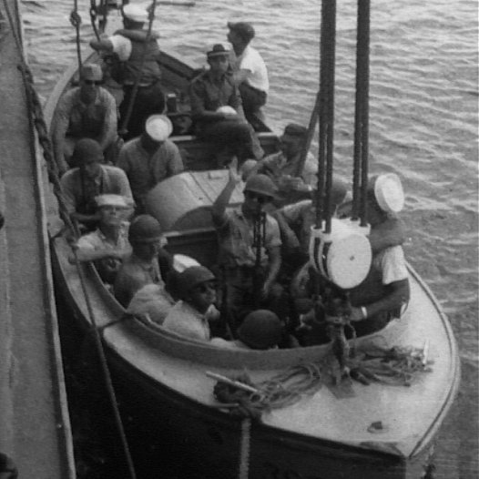 Closeup of sailors on boat being lowered into water